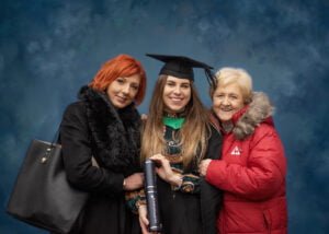 A graduate in regalia posing with her mother and grandmother during a Nottingham graduation photoshoot.