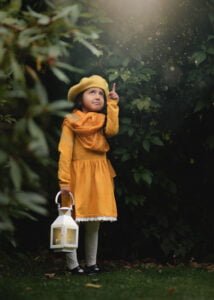 Girl holding a lantern during a creative photoshoot for kids in Nottingham.