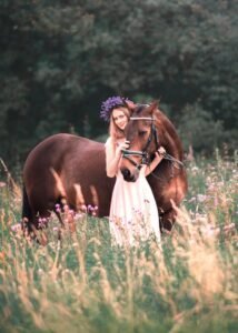 Woman with a lavender crown embracing her horse during an equestrian photoshoot