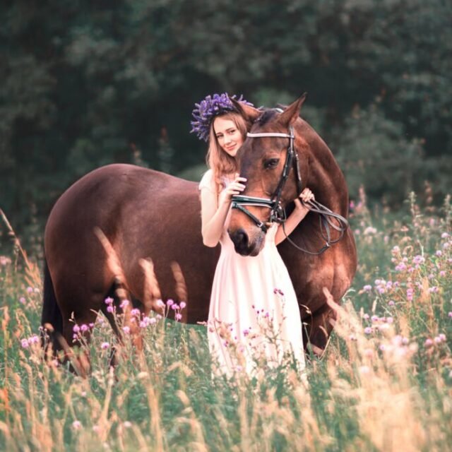 Woman with a lavender crown embracing her horse during an equestrian photoshoot