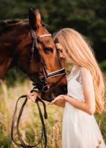 Woman sharing a tender moment with her horse during a close-up equine photoshoot