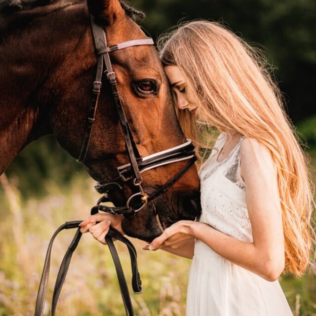 Woman sharing a tender moment with her horse during a close-up equine photoshoot