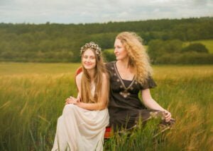 Mother and daughter sitting in a field during an outdoor photoshoot in Nottingham