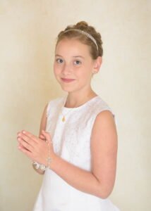 Close-up of a girl holding a rosary during her First Holy Communion Photography session in Nottingham.