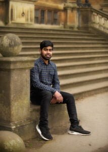 Man smiling on stone steps in Nottingham during a friends photoshoot
