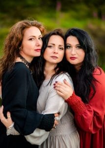 Three women posing together outdoors during a creative friends photoshoot in Nottingham