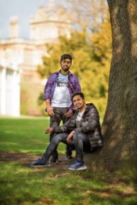 Two men relaxing under a tree in Nottingham during a friends photoshoot