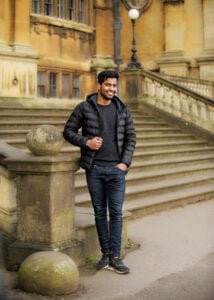 Man standing by stone steps in front of a historic building during a friends photoshoot in Nottingham