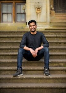 Man smiling while sitting on stone steps during a Nottingham friendship photography session