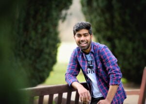 Man laughing and leaning on a park bench during a Nottingham friends photoshoot