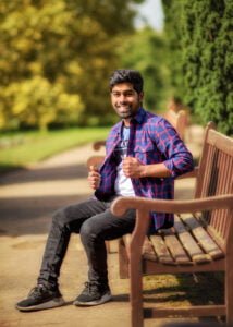 Man on park bench smiling in sunlight during a friends photoshoot in Nottinghamshire