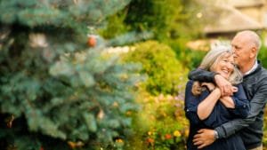 Older couple embracing in a garden during their Nottingham anniversary photography session