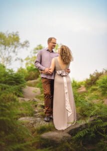 Couple holding hands on a forest path during Nottingham anniversary photography session