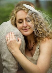 Close-up of woman embracing her partner with a veil headpiece in Nottingham anniversary photoshoot