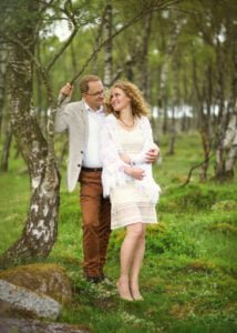 Couple leaning against birch tree in Nottingham forest during an anniversary photoshoot