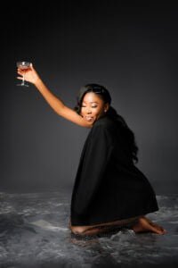 Joyful Toast to 40: With a beaming smile and a glass raised high, a woman exudes the sheer happiness of celebrating her 40th birthday in style.