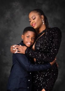 Mother in a sparkling black dress hugging her son during a heartfelt birthday photoshoot in Nottingham studio.
