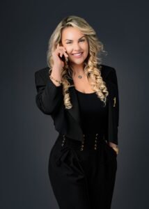 Smiling businesswoman in formal black attire on the phone during a professional business photoshoot, ideal for branding and corporate profiles.