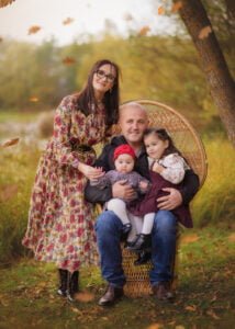 Family outdoor photography with a wicker chair in Colliers Wood during autumn.