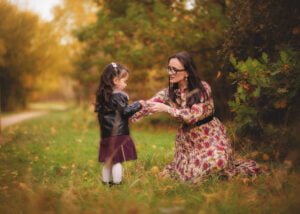 Mother helping her daughter during a family outdoor photography session in Nottingham.
