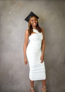 Radiant Nottingham graduate smiling in her cap and gown, diploma in hand, ready to step into the future.