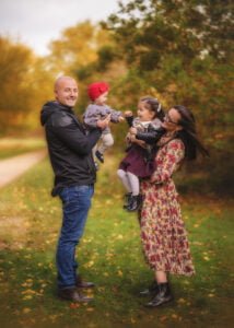 Family playing and laughing during a family outdoor photography session in Nottingham.