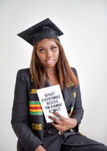 Nottingham graduate in cap holding a book, representing readiness for the professional world