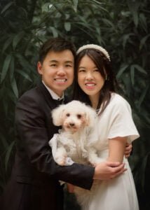 Couple embracing their dog during a pre-wedding photoshoot at Elvaston Castle surrounded by nature.