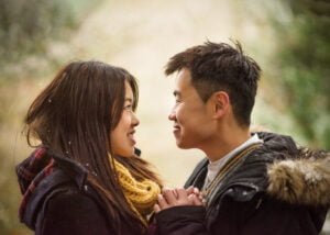 Couple gazing into each other’s eyes during their snowy pre-wedding photoshoot at Elvaston Castle.