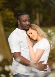 Engaged couple enjoying a romantic spring engagement photoshoot surrounded by blooming flowers.