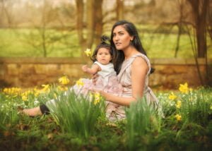 A serene Mother and Child Photoshoot featuring a mom and baby surrounded by daffodils in Nottingham.