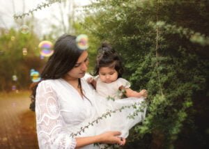 A loving moment during a Mother and Child Photoshoot in Nottingham with soft bubbles creating a magical effect.