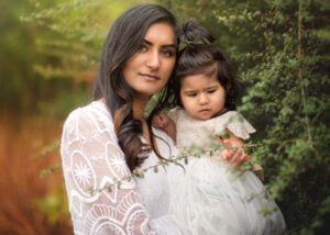 A mother cradles her child while gazing thoughtfully during a Mother and Child Photoshoot in Nottingham.
