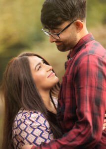A close-up of a couple gazing at each other during their outdoor photoshoot, emphasizing emotional connection and natural beauty.