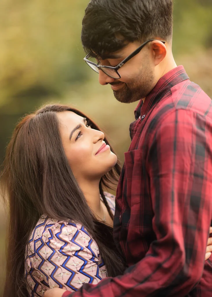 A close-up of a couple gazing at each other during their outdoor photoshoot, emphasizing emotional connection and natural beauty.