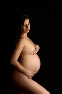 Elegant nude maternity portrait of an expectant mother in a Nottingham studio during a maternity photoshoot.