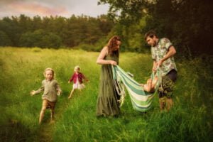 Parents swinging their child in a hammock during a Nottingham outdoor family photoshoot.