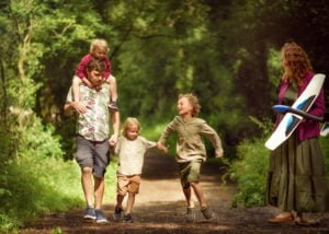 Family walking together on a forest trail during a Nottingham outdoor family photoshoot.