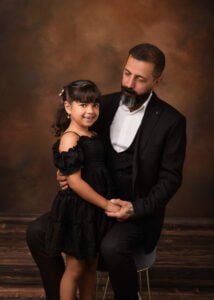 Father and daughter posing together during a family maternity session in Nottingham.