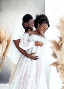 Expectant parents sharing a joyful moment captured by a maternity photographer in Nottingham.