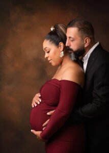 Maternity photography in Nottingham: A couple in a tender embrace, awaiting their child.