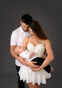 Parents holding baby close during a family photography session in Nottingham studio.