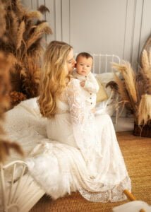 Mother cuddling baby during a baby photography session in a boho-inspired Eastwood studio.