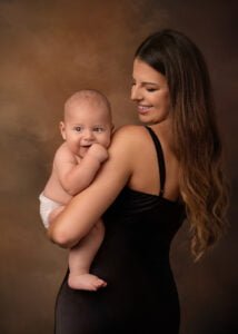 Mother holding her baby during a professional family photography session in Nottingham.