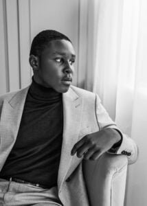 Elegant black-and-white men’s photoshoot featuring a confident man in a tailored suit.