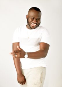 Fun and relaxed men’s photoshoot featuring a joyful man in a white t-shirt, exuding positive energy.