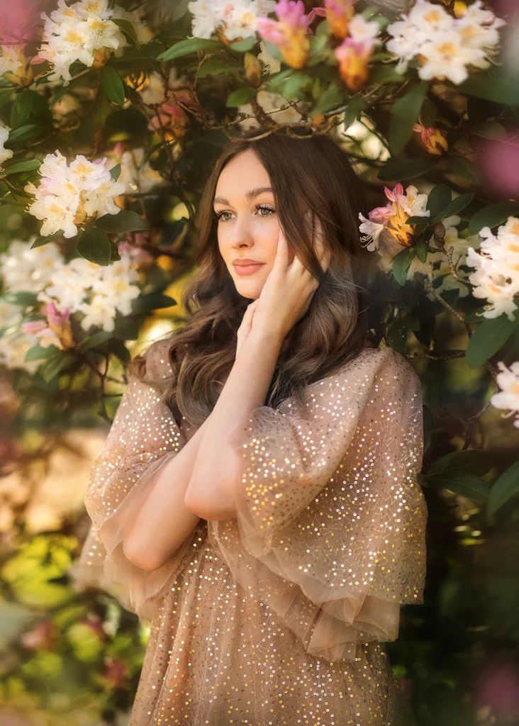 Champagne sparkle dress worn by woman framed in blooming branches
