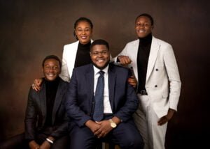 Elegant family portrait including a graduate, dressed in formal attire, celebrating a significant academic milestone together.