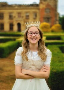 portrait photo of a girl in white dress with a crown