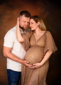 Nottingham maternity photo of couple embracing and touching foreheads during pregnancy